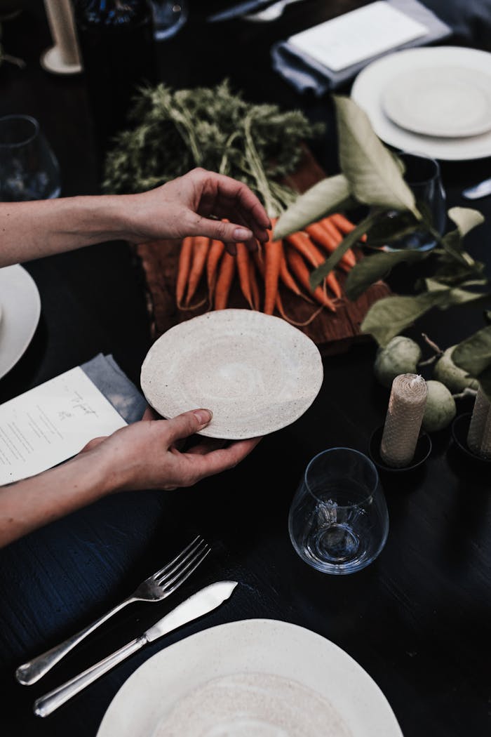 Woman with plate near table with vegetables